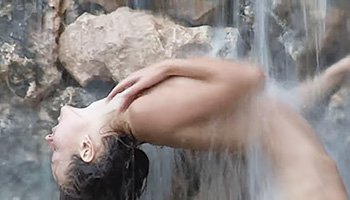 Dark-haired beauty at the waterfall